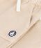 Babies' cargo-style trousers in plain cotton with a badge beige
