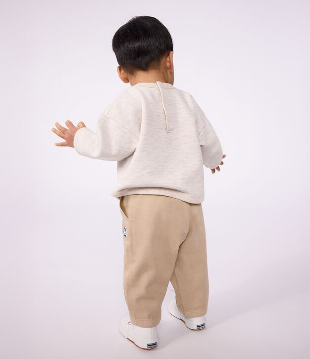 Babies' cargo-style trousers in plain cotton with a badge beige