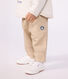 Babies' cargo-style trousers in plain cotton with a badge
